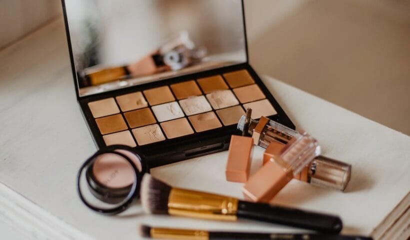 assorted cosmetic products on white and brown wooden drawer cabinet