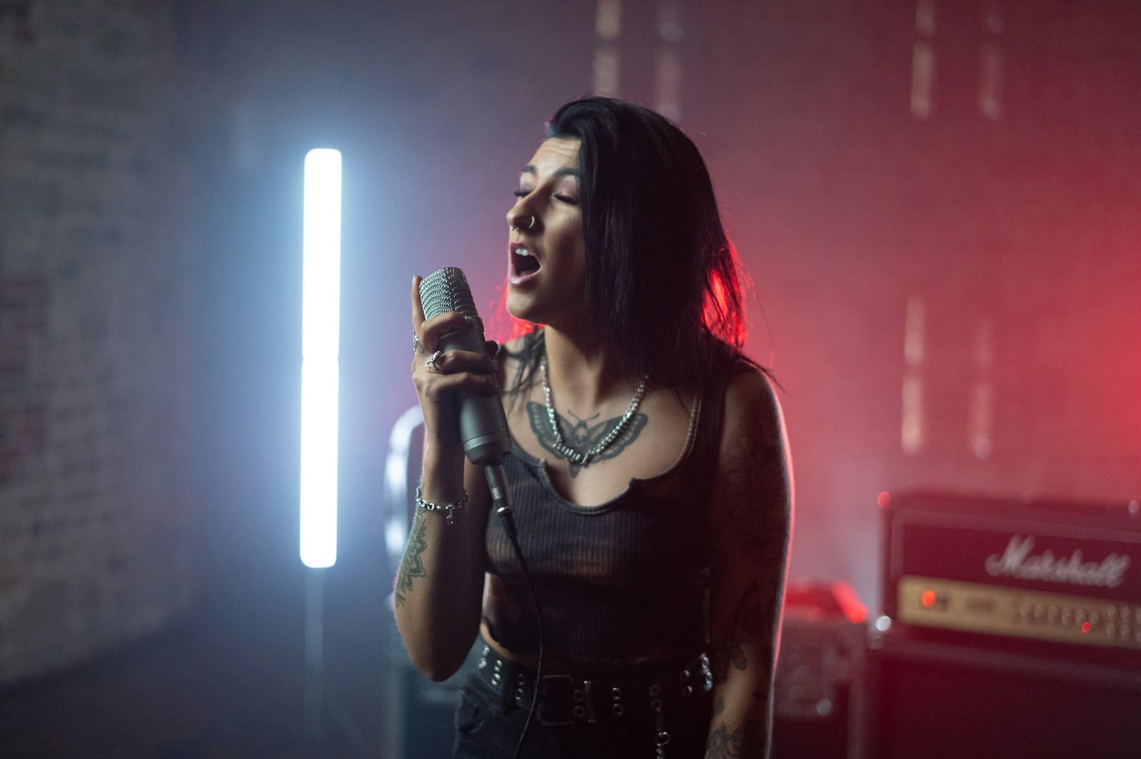 woman in black tank top singing