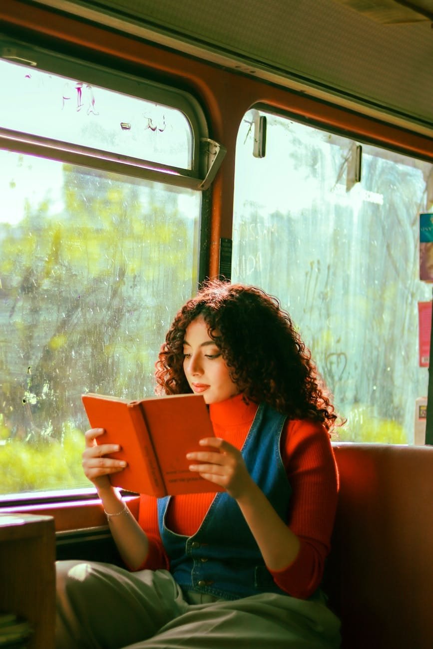 brunette reading book on bus