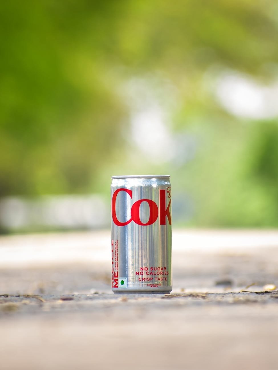 close up of a coke can outdoors in india