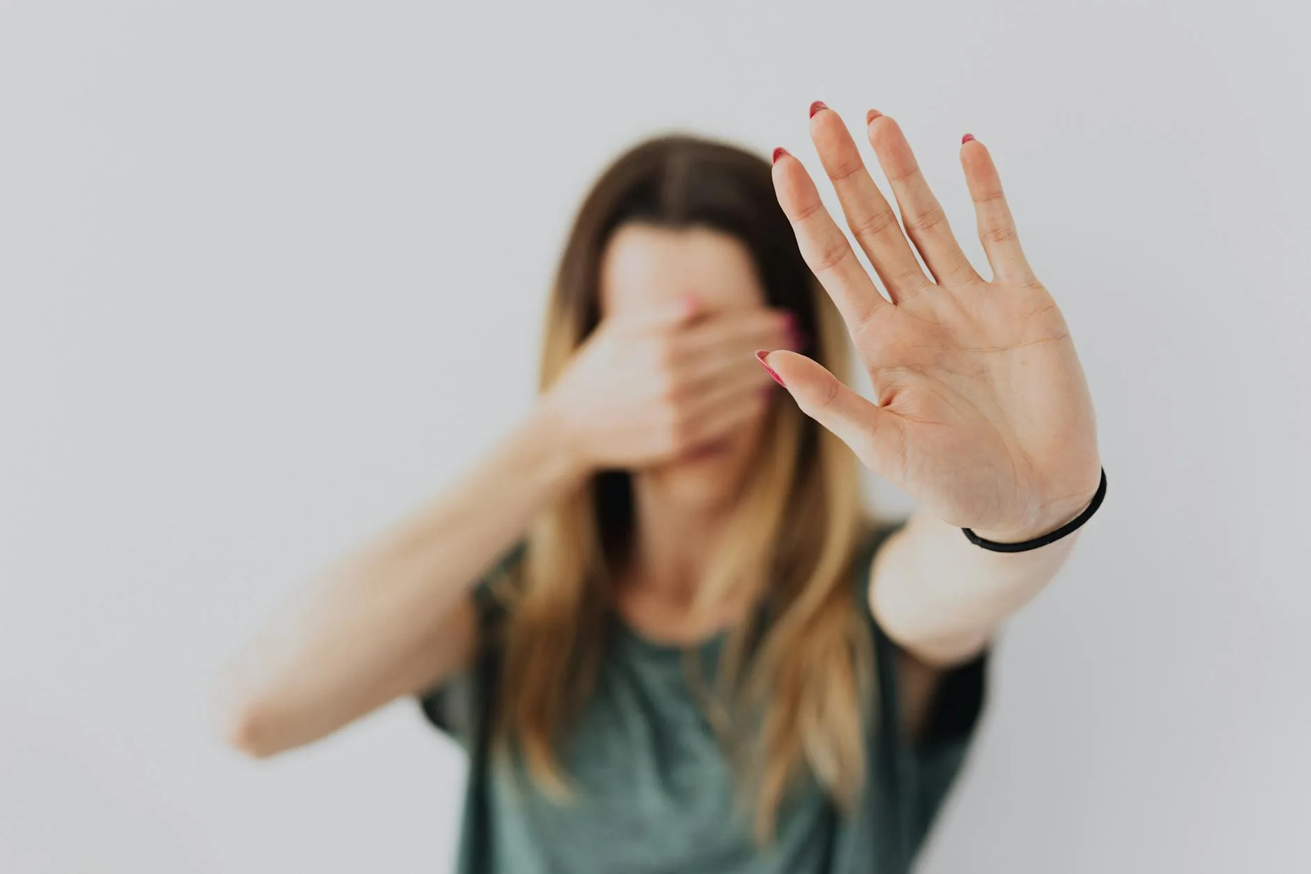 woman covering her face with her hands