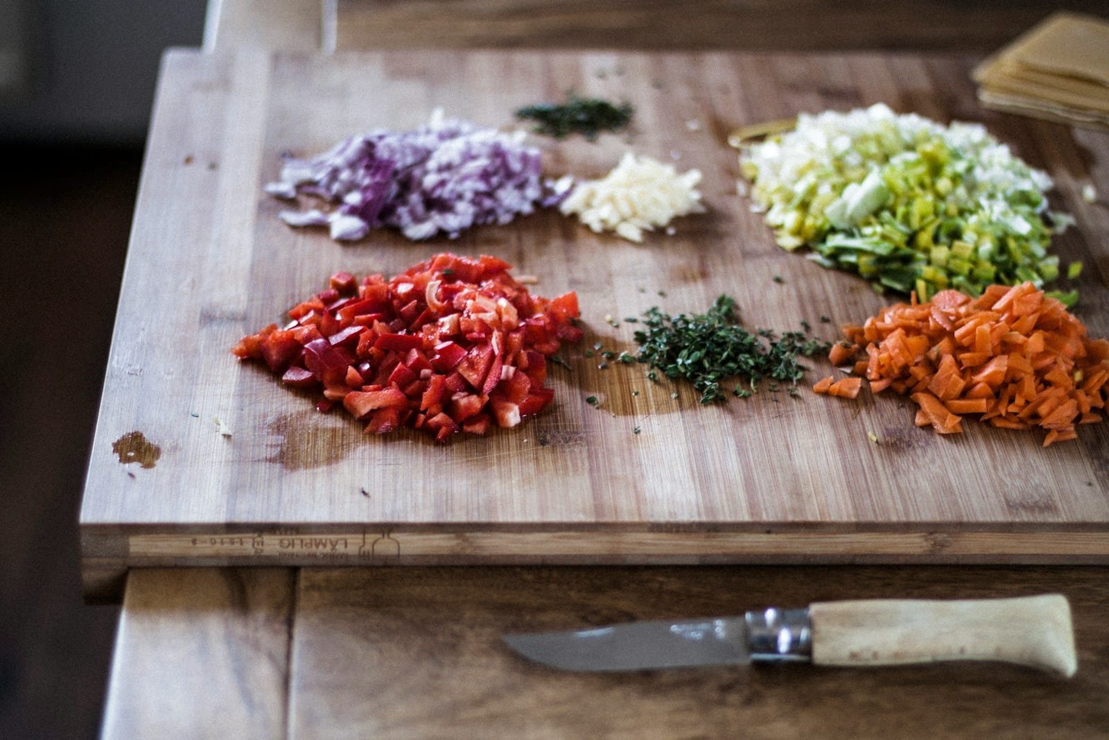 sliced vegetables on brown wooden chopping board
