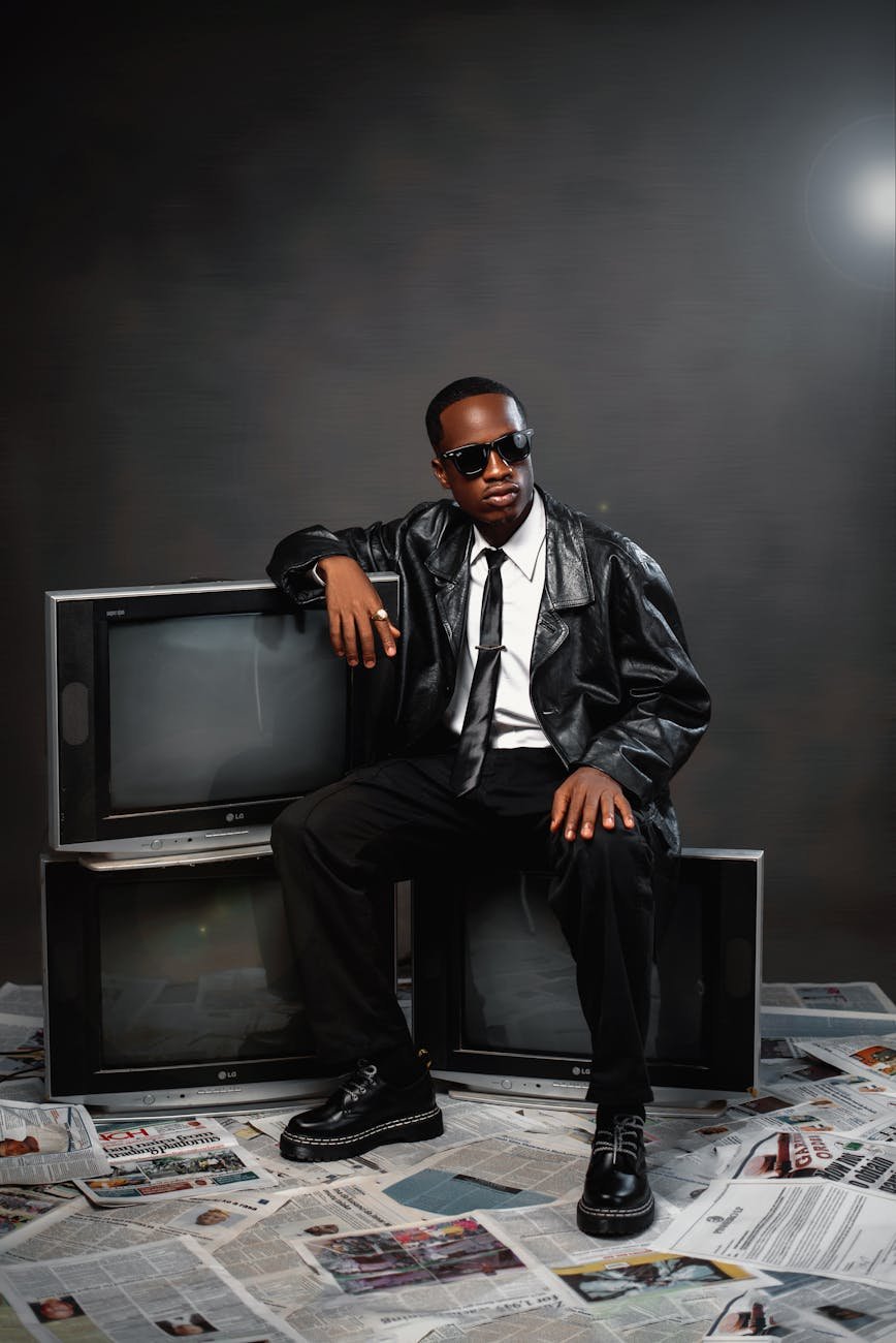 stylish individual in leather with retro tvs
