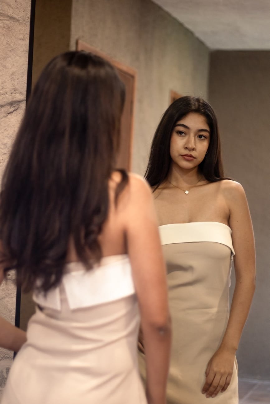 elegant woman looking in mirror indoors