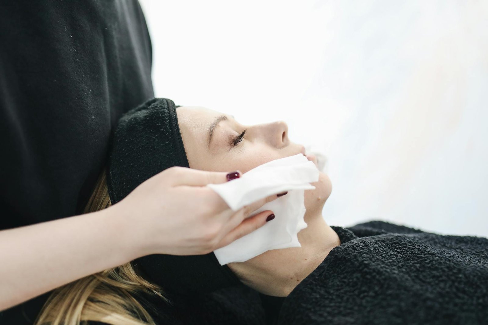 photo of person using a tissue to dry a woman s face