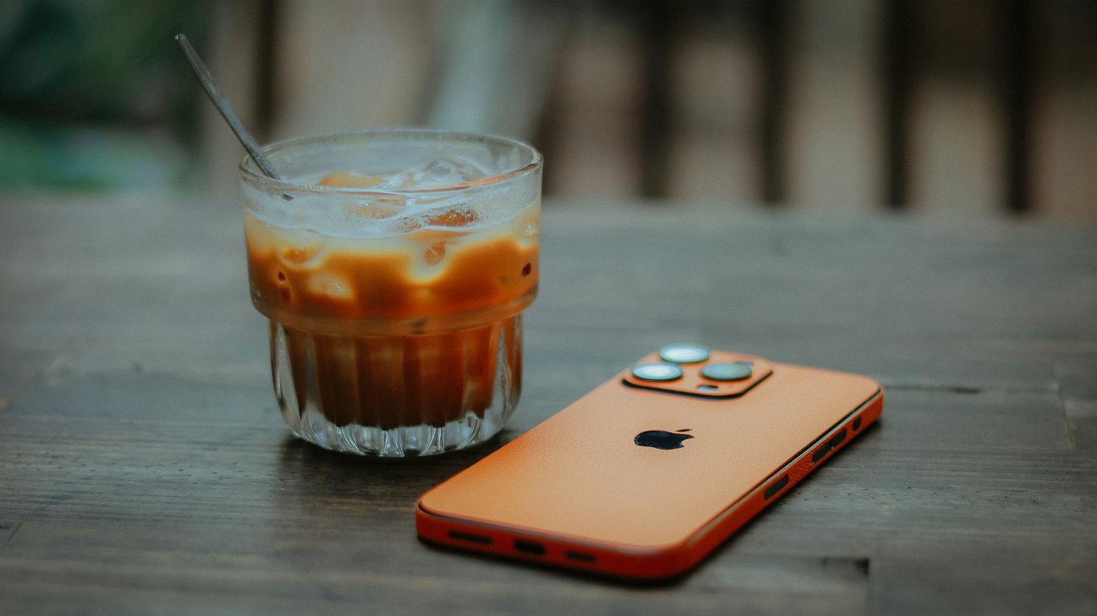 iced coffee with smartphone on wooden table