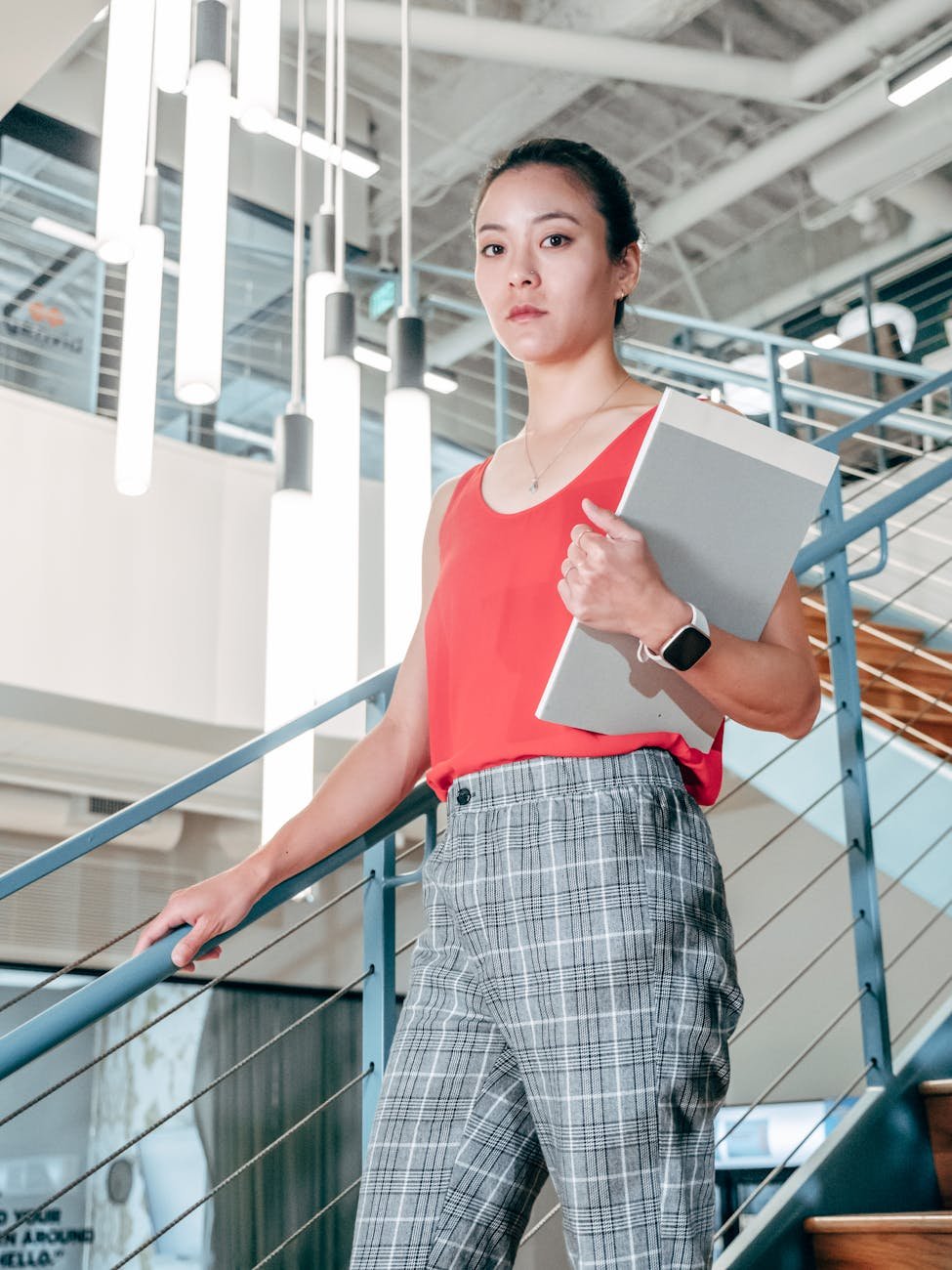 female employee holding on handrails