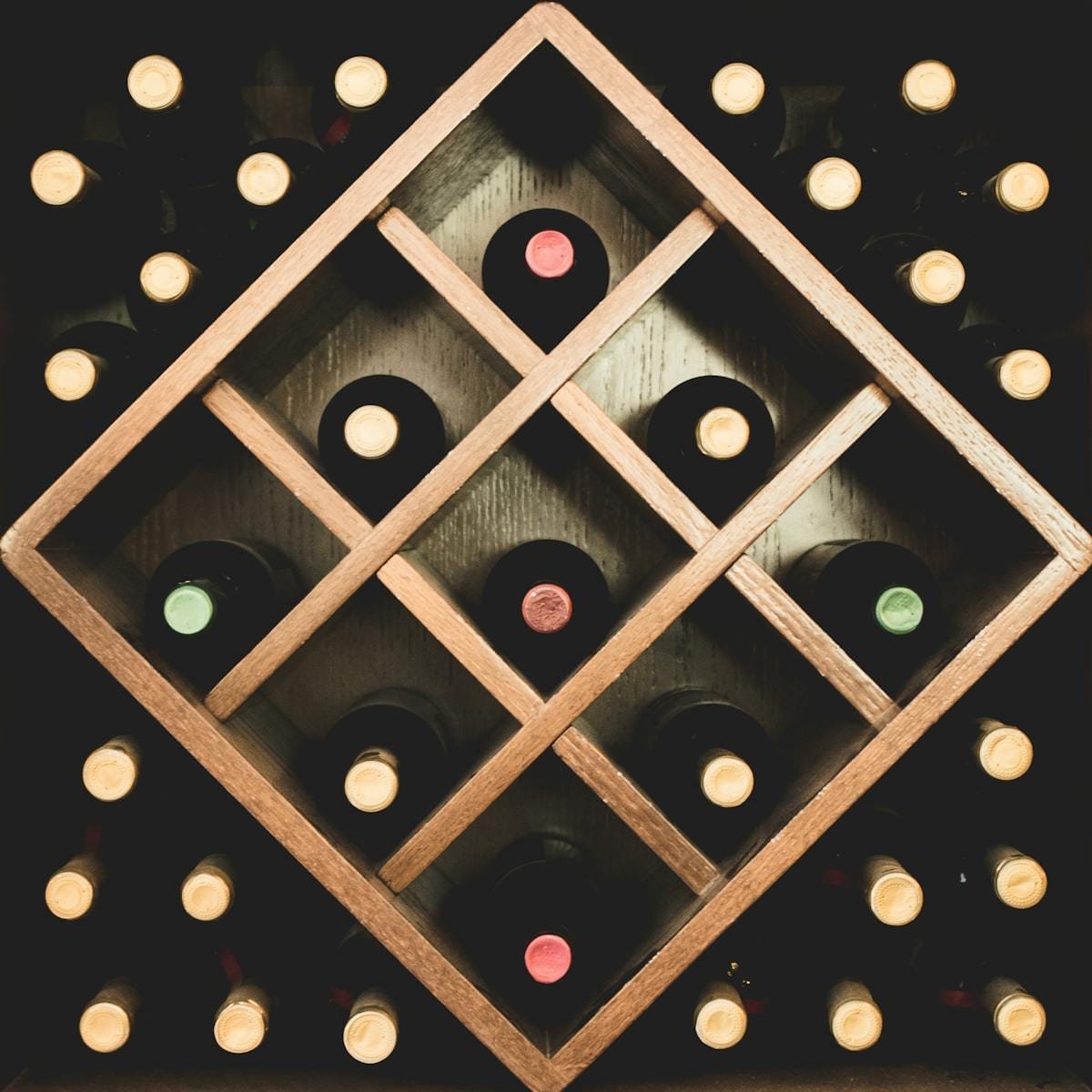 Close-up of a wine bottle rack displaying assorted wines in an elegant setting.