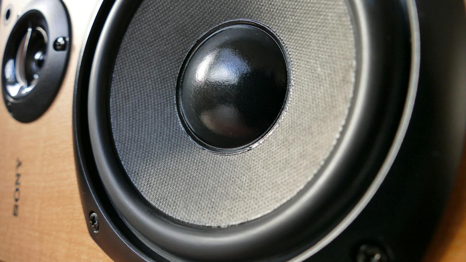 closed up photography of brown wooden framed sony speaker